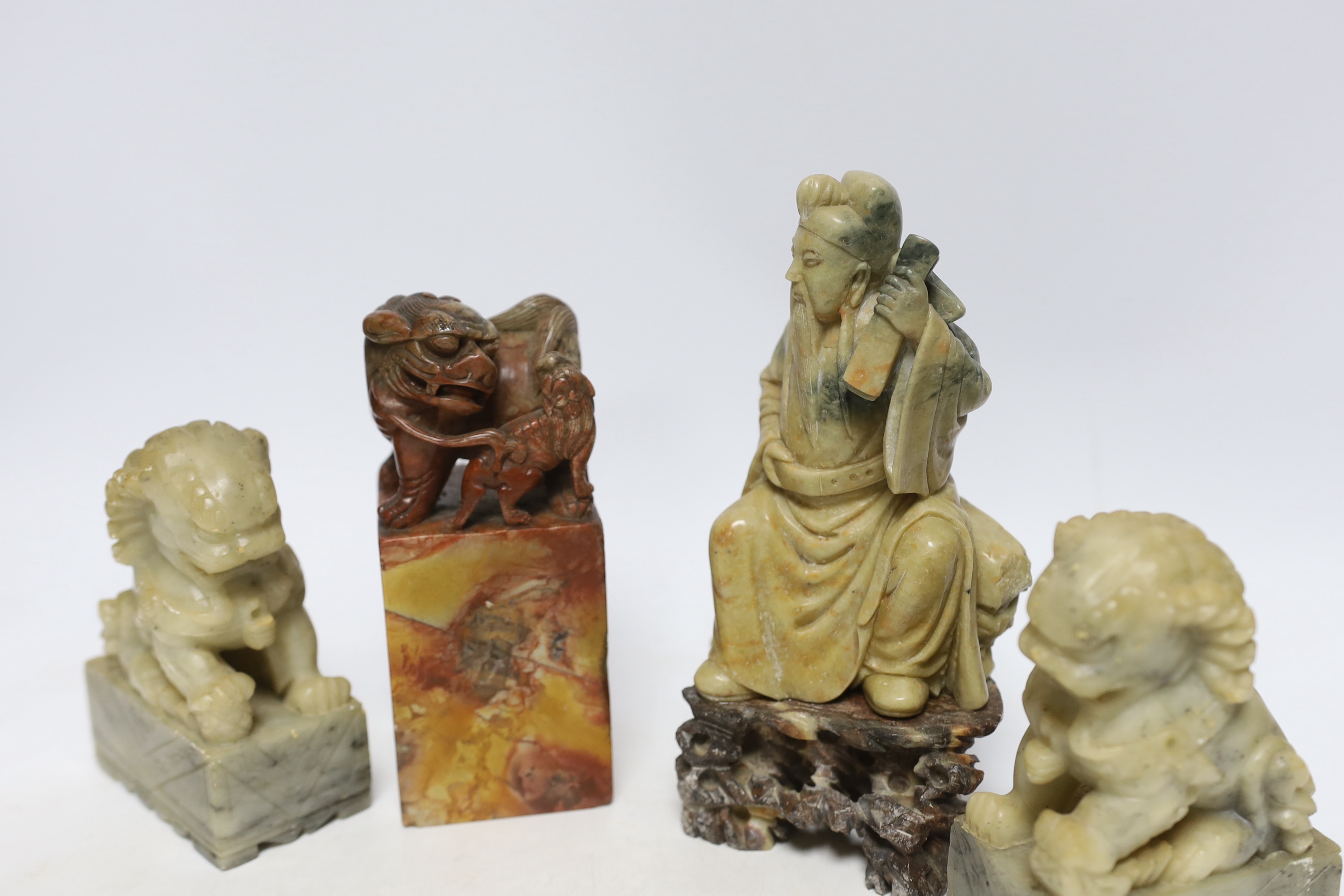 Two Chinese soapstone figures and a pair of Buddhist lion seals, tallest 19.5cm